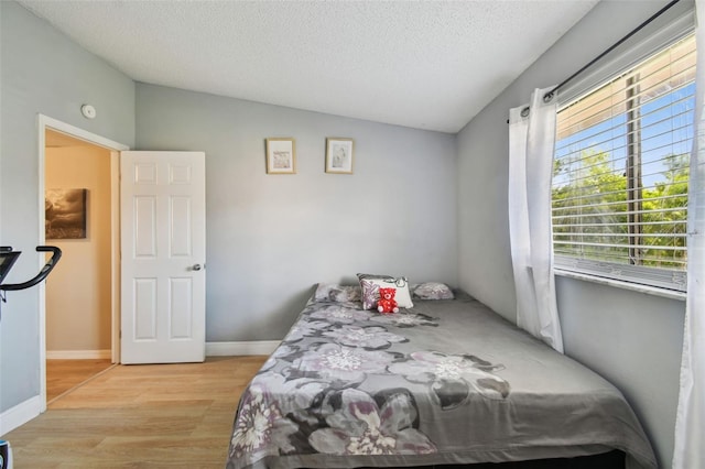 4017 Cedar Limb Ct, Tampa, FL 33614 - bedroom featuring vaulted ceiling, light wood-style floors, a textured ceiling, and baseboards