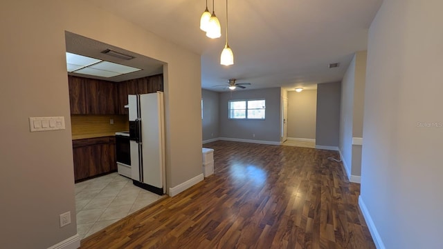 4021 19th St N, Saint Petersburg, FL 33714 - kitchen with freestanding refrigerator, range, ceiling fan, light wood-type flooring, and tasteful backsplash