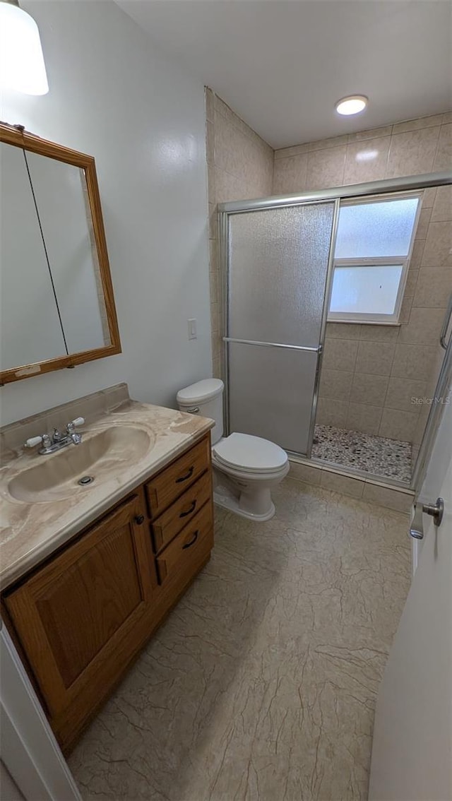 4021 19th St N, Saint Petersburg, FL 33714 - bathroom with vanity, toilet, and a stall shower