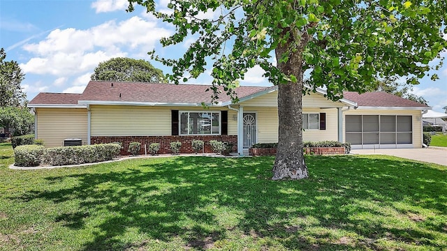 9755 SE 176th St, Summerfield, FL 34491 - single story home with a front yard, concrete driveway, a garage, brick siding, and central air condition unit