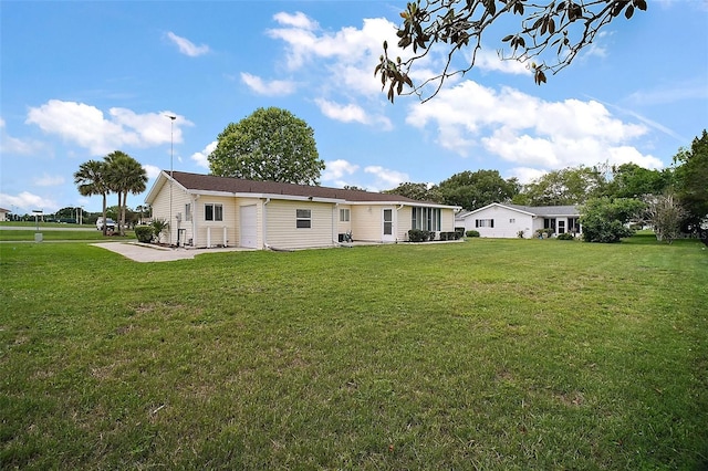 9755 SE 176th St, Summerfield, FL 34491 - rear view of property featuring a lawn and a patio