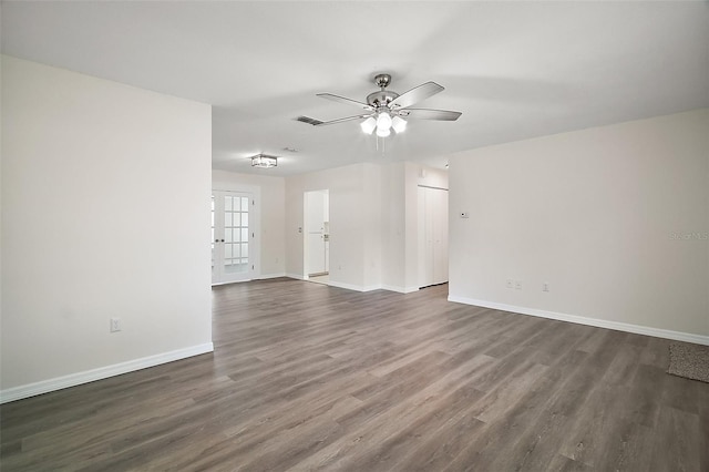 9755 SE 176th St, Summerfield, FL 34491 - unfurnished living room featuring ceiling fan, dark wood-style floors, and baseboards
