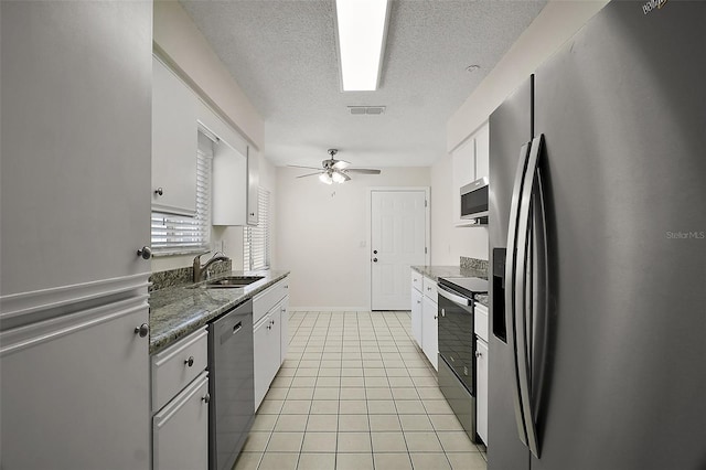 9755 SE 176th St, Summerfield, FL 34491 - kitchen featuring stainless steel appliances, a sink, a textured ceiling, white cabinets, and ceiling fan