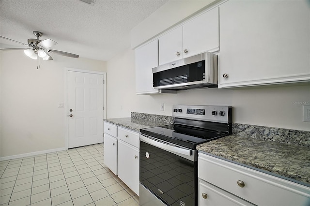 9755 SE 176th St, Summerfield, FL 34491 - kitchen with stainless steel appliances, ceiling fan, white cabinets, a textured ceiling, and light tile patterned flooring