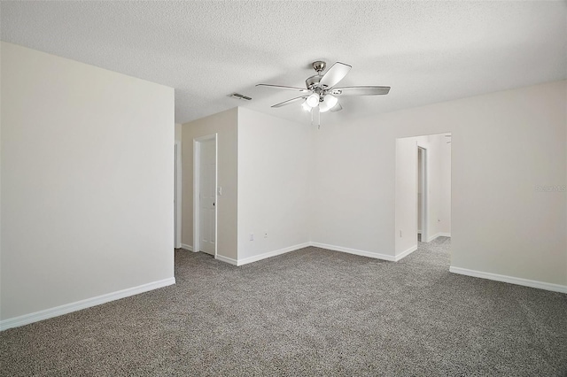 9755 SE 176th St, Summerfield, FL 34491 - spare room with ceiling fan, dark colored carpet, a textured ceiling, and baseboards