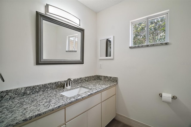 9755 SE 176th St, Summerfield, FL 34491 - bathroom featuring vanity, baseboards, and wood finished floors