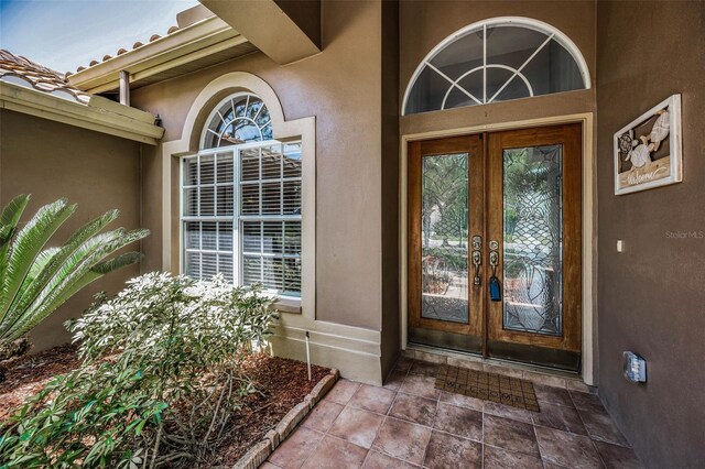 1516 E Lake Woodlands Pkwy, Oldsmar, FL 34677 - doorway to property featuring french doors and stucco siding