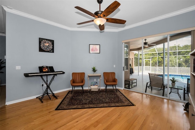 1516 E Lake Woodlands Pkwy, Oldsmar, FL 34677 - living area featuring ceiling fan, wood finished floors, crown molding, baseboards, and a sunroom