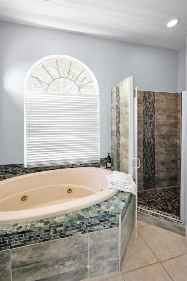 1516 E Lake Woodlands Pkwy, Oldsmar, FL 34677 - full bathroom with a tub with jets, tile patterned floors, and a stall shower