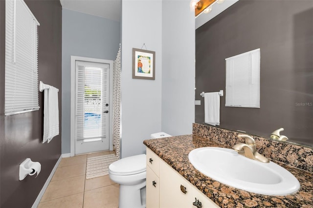 1516 E Lake Woodlands Pkwy, Oldsmar, FL 34677 - bathroom featuring vanity, toilet, tile patterned flooring, and baseboards
