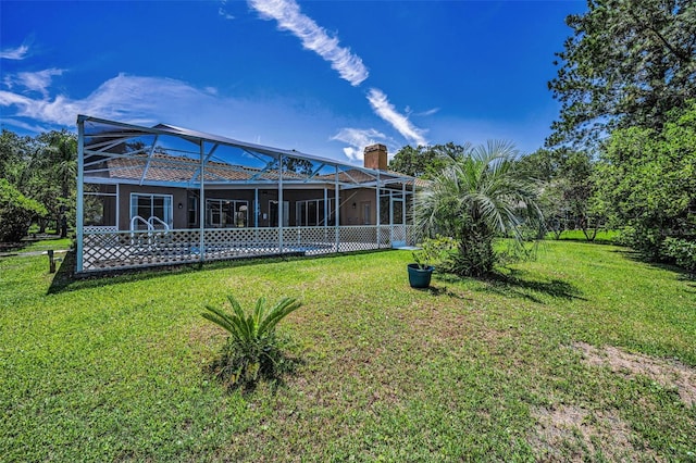 1516 E Lake Woodlands Pkwy, Oldsmar, FL 34677 - rear view of property featuring a lawn, a chimney, and glass enclosure