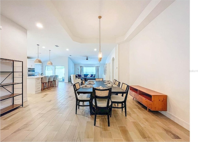 12010 Jackson Landing Pl, Tampa, FL 33624 - dining room with light wood-style floors, recessed lighting, baseboards, and a tray ceiling