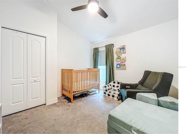 12010 Jackson Landing Pl, Tampa, FL 33624 - carpeted bedroom featuring lofted ceiling, a closet, ceiling fan, baseboards, and a crib