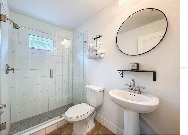 12010 Jackson Landing Pl, Tampa, FL 33624 - full bathroom with toilet, a stall shower, tile patterned floors, and baseboards