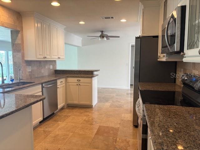 12055 4th St E, Treasure Island, FL 33706 - kitchen featuring stainless steel appliances, a sink, backsplash, ceiling fan, and recessed lighting