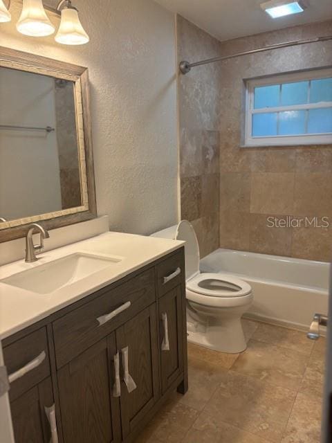 12055 4th St E, Treasure Island, FL 33706 - bathroom with toilet, vanity, a textured wall, and bathing tub / shower combination