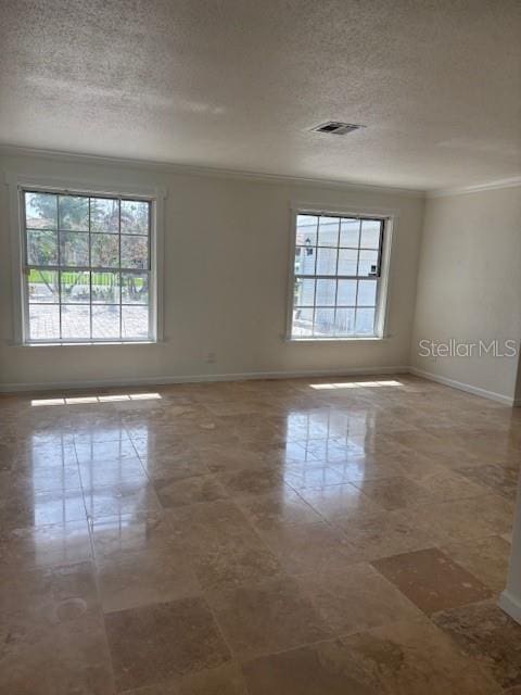 12055 4th St E, Treasure Island, FL 33706 - spare room with crown molding, baseboards, and a textured ceiling