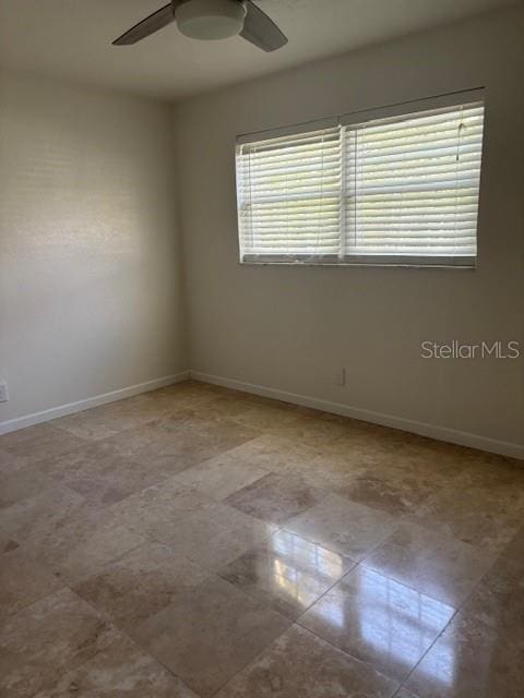 12055 4th St E, Treasure Island, FL 33706 - empty room featuring a ceiling fan and baseboards
