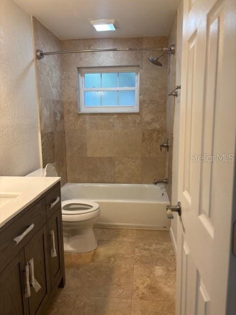 12055 4th St E, Treasure Island, FL 33706 - full bathroom featuring toilet, vanity, shower / bathtub combination, and tile patterned floors