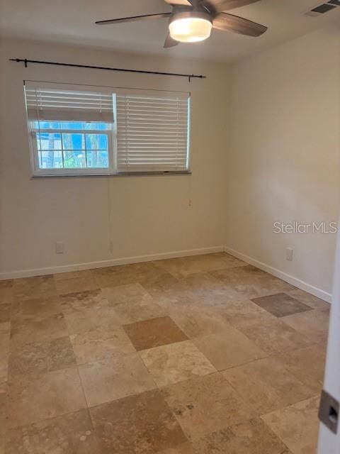 12055 4th St E, Treasure Island, FL 33706 - unfurnished room featuring a ceiling fan and baseboards
