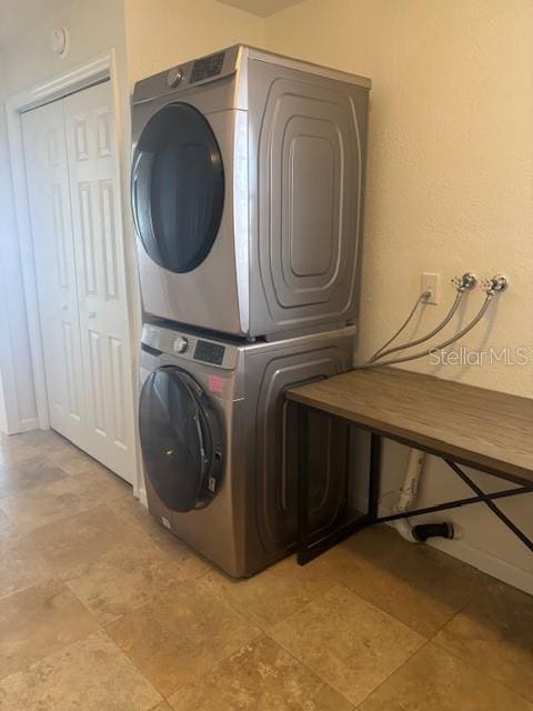 12055 4th St E, Treasure Island, FL 33706 - laundry room with stacked washer and clothes dryer and baseboards