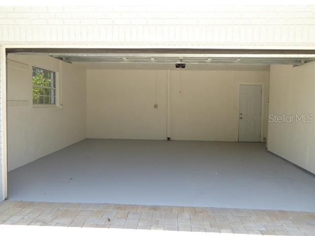 12055 4th St E, Treasure Island, FL 33706 - garage featuring a garage door opener