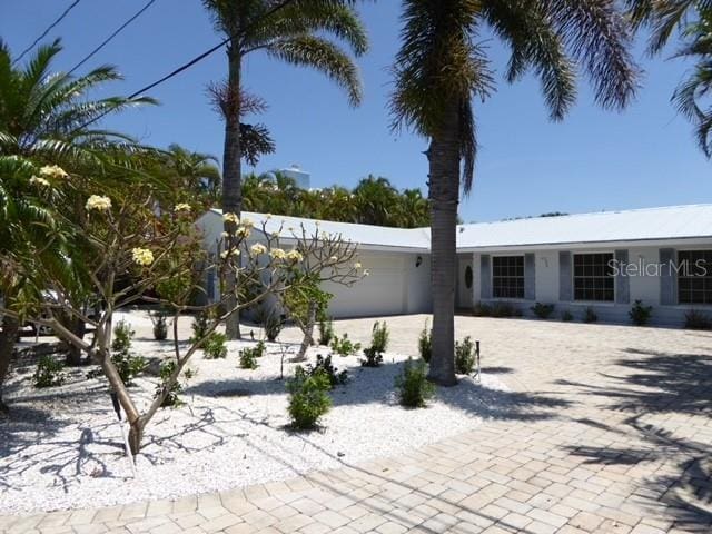 12055 4th St E, Treasure Island, FL 33706 - view of front of house with a garage and driveway