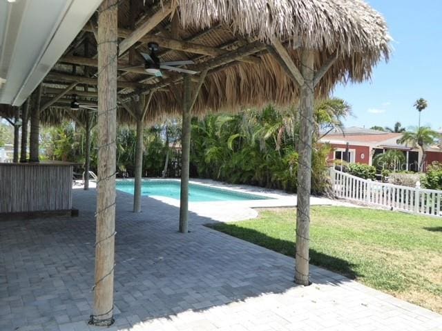 12055 4th St E, Treasure Island, FL 33706 - swimming pool featuring a ceiling fan, a gazebo, and a patio area