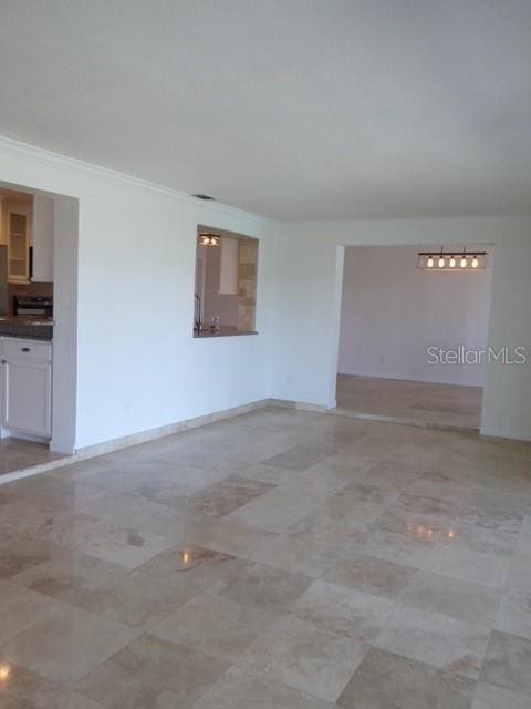 12055 4th St E, Treasure Island, FL 33706 - empty room with crown molding and baseboards