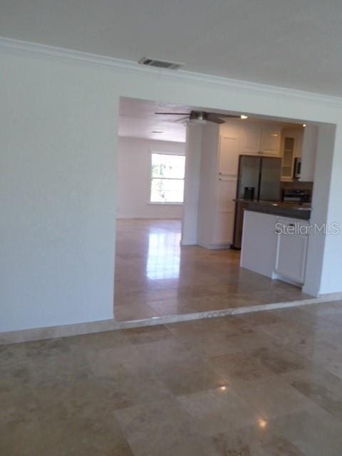 12055 4th St E, Treasure Island, FL 33706 - kitchen featuring ornamental molding, dark countertops, and refrigerator with ice dispenser
