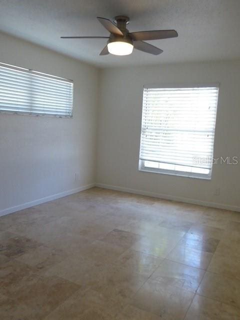 12055 4th St E, Treasure Island, FL 33706 - spare room with plenty of natural light and a ceiling fan