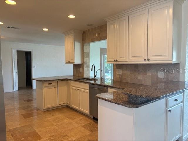 12055 4th St E, Treasure Island, FL 33706 - kitchen featuring stainless steel dishwasher, a peninsula, tasteful backsplash, and recessed lighting