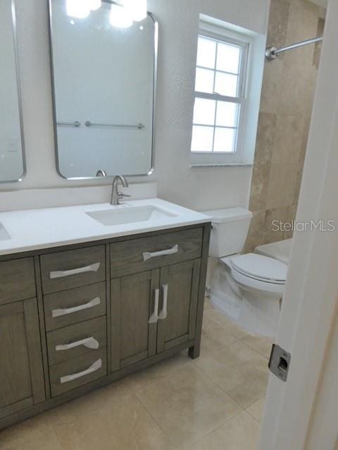 12055 4th St E, Treasure Island, FL 33706 - full bath featuring double vanity, tile patterned flooring, and a shower