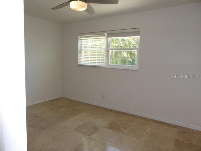 12055 4th St E, Treasure Island, FL 33706 - unfurnished room with a ceiling fan and baseboards