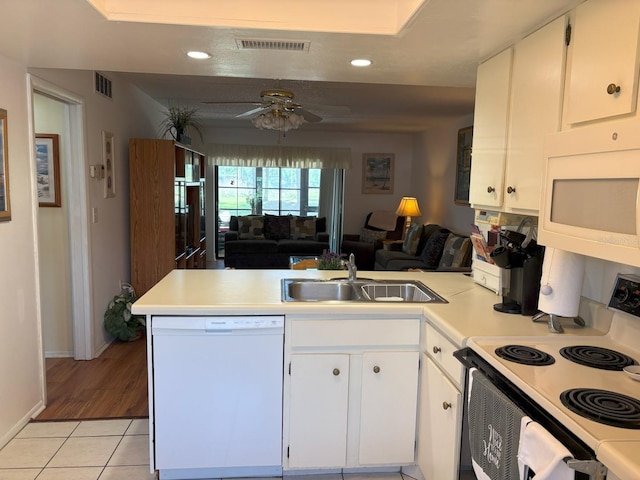 303 Meadow Ln, Oldsmar, FL 34677 - kitchen with white appliances, a peninsula, open floor plan, a sink, and light tile patterned floors