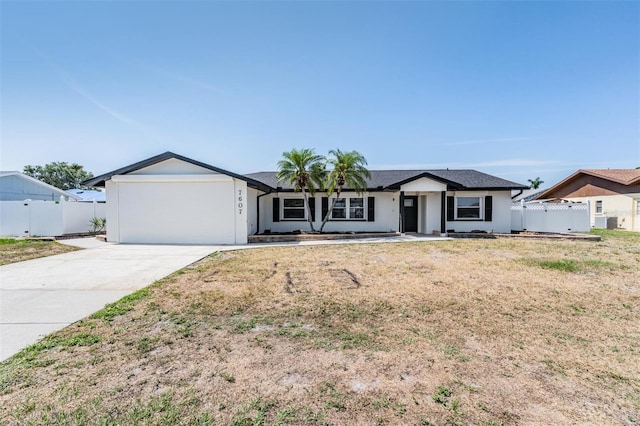 7607 22nd Ave W, Bradenton, FL 34209 - ranch-style home with concrete driveway, an attached garage, and stucco siding