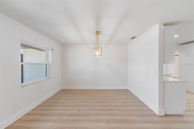 7607 22nd Ave W, Bradenton, FL 34209 - unfurnished dining area featuring light wood-type flooring and baseboards