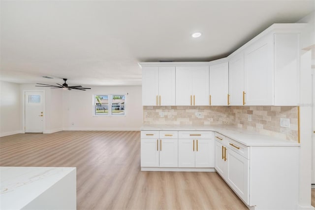7607 22nd Ave W, Bradenton, FL 34209 - kitchen featuring ceiling fan, light wood-style flooring, decorative backsplash, white cabinetry, and recessed lighting