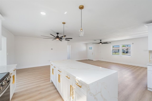 7607 22nd Ave W, Bradenton, FL 34209 - kitchen with a ceiling fan, electric range, light wood finished floors, open floor plan, and recessed lighting