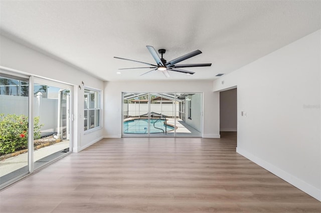 7607 22nd Ave W, Bradenton, FL 34209 - empty room featuring light wood finished floors, baseboards, and a ceiling fan