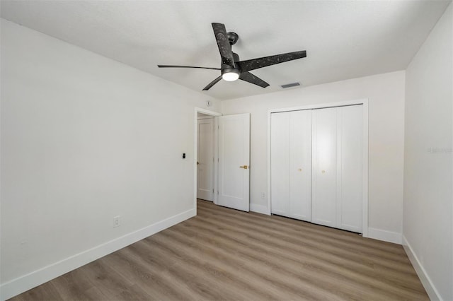 7607 22nd Ave W, Bradenton, FL 34209 - unfurnished bedroom featuring light wood-style flooring, baseboards, and a closet