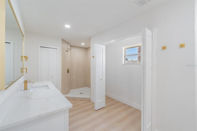 7607 22nd Ave W, Bradenton, FL 34209 - full bathroom featuring tiled shower, vanity, wood finished floors, recessed lighting, and baseboards