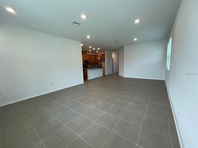28547 Hillcrest Valley Blvd, Wesley Chapel, FL 33543 - unfurnished living room featuring recessed lighting, baseboards, and dark tile patterned floors