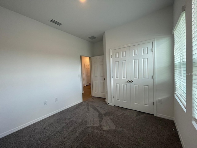 28547 Hillcrest Valley Blvd, Wesley Chapel, FL 33543 - unfurnished bedroom featuring carpet, multiple windows, baseboards, and a closet