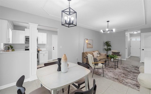 2613 E 113th Ave, Tampa, FL 33612 - dining area featuring a chandelier, light tile patterned flooring, and baseboards