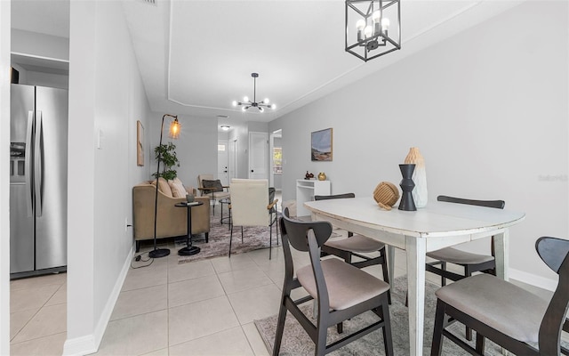2613 E 113th Ave, Tampa, FL 33612 - dining space featuring a chandelier, light tile patterned floors, and baseboards