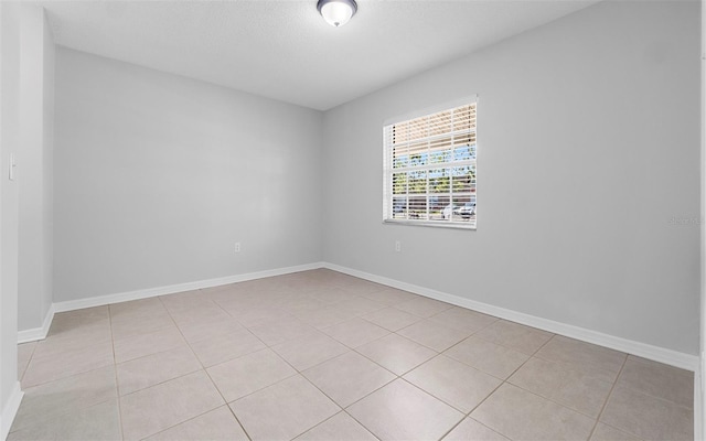 2613 E 113th Ave, Tampa, FL 33612 - empty room with light tile patterned floors and baseboards