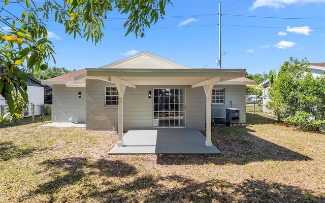 2613 E 113th Ave, Tampa, FL 33612 - back of house with a patio, central AC, and a shingled roof