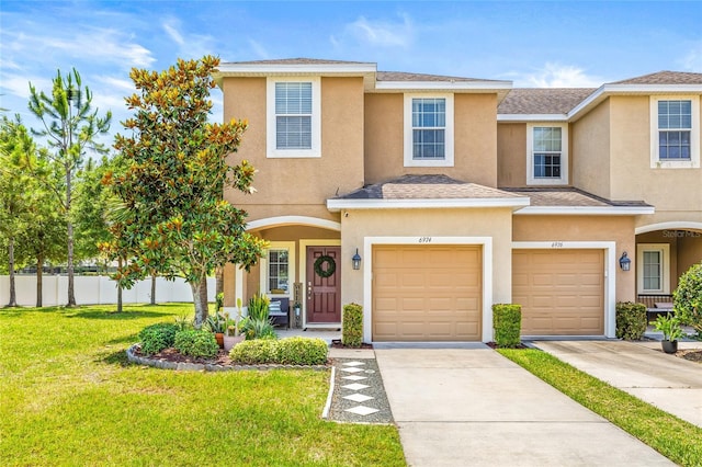 6974 Holly Heath Dr, Riverview, FL 33578 - view of property with stucco siding, an attached garage, and driveway