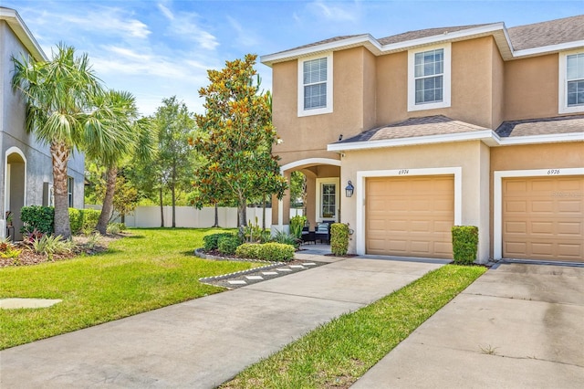 6974 Holly Heath Dr, Riverview, FL 33578 - view of property featuring stucco siding, an attached garage, concrete driveway, and roof with shingles